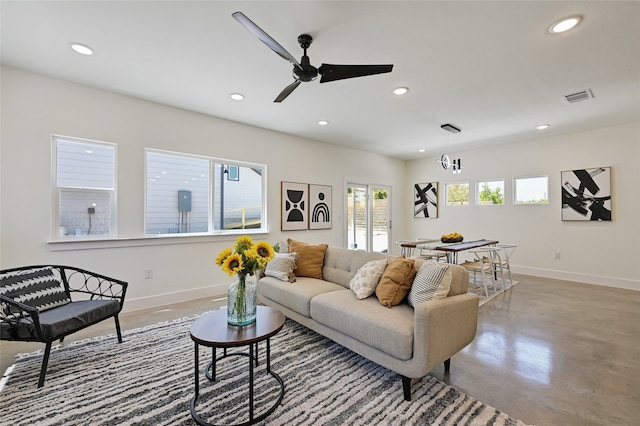 living room featuring visible vents, concrete flooring, and recessed lighting