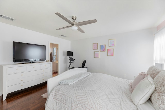 bedroom with ceiling fan, dark hardwood / wood-style floors, and ensuite bath