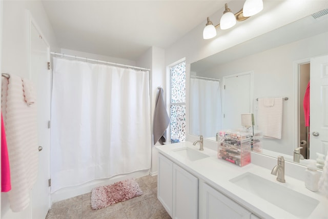 bathroom with tile patterned floors, vanity, and shower / bath combo with shower curtain