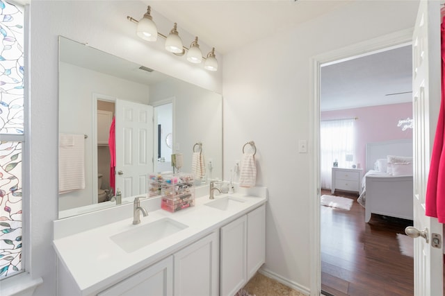 bathroom featuring hardwood / wood-style flooring, vanity, and toilet