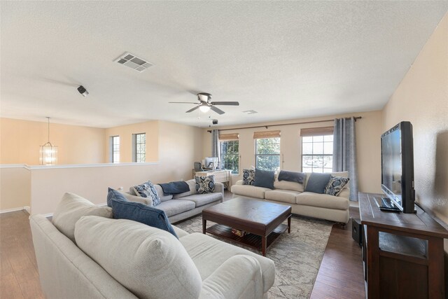 living room with wood-type flooring and a textured ceiling