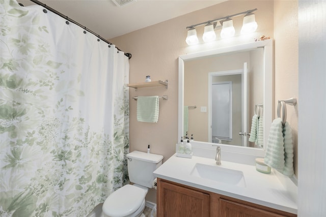 bathroom featuring a shower with curtain, vanity, and toilet