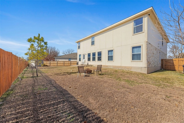 back of house featuring a yard