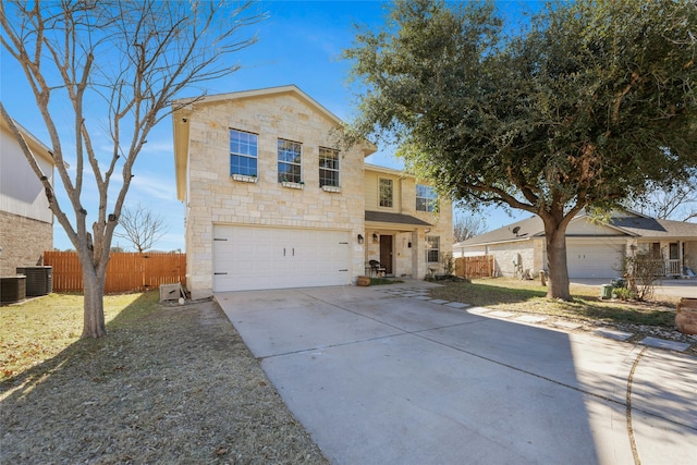 front of property featuring a garage and central AC