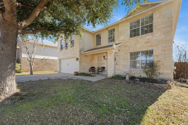 view of front of property featuring a garage and a front yard