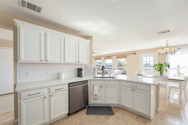 kitchen featuring sink, white cabinetry, tasteful backsplash, dishwasher, and a healthy amount of sunlight