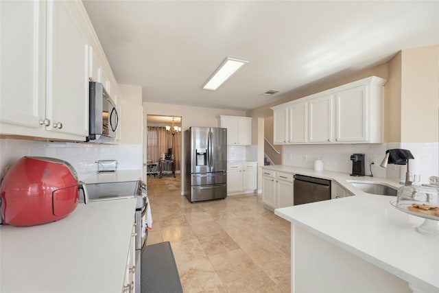 kitchen with tasteful backsplash, stainless steel appliances, and white cabinets