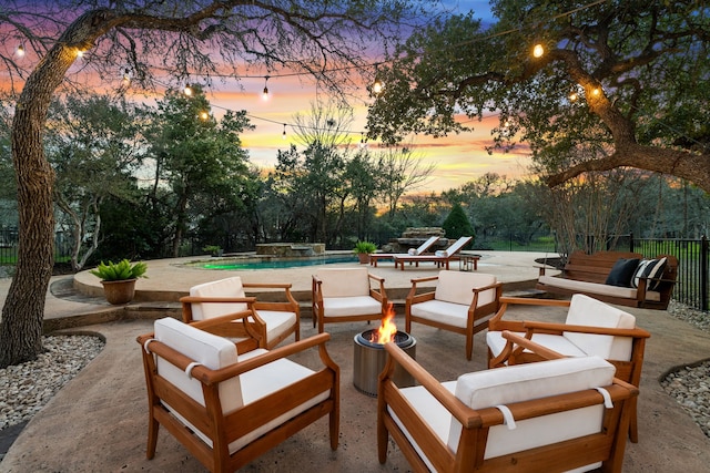 patio terrace at dusk featuring outdoor lounge area