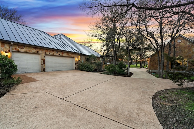 property exterior at dusk featuring a garage