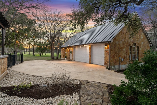 view of garage at dusk