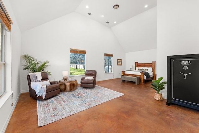 bedroom with high vaulted ceiling and concrete flooring