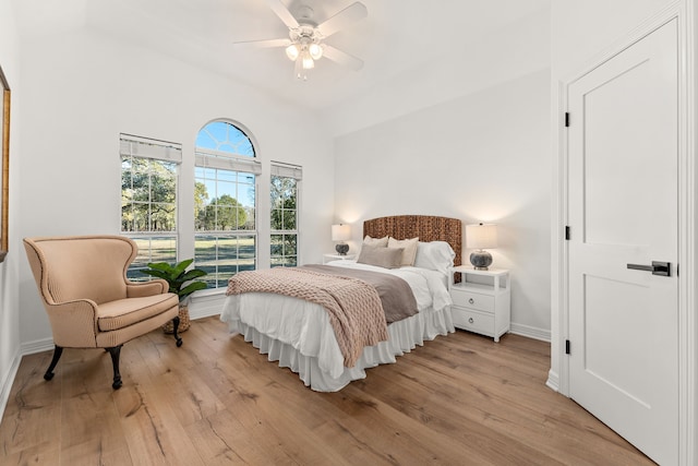 bedroom featuring vaulted ceiling, ceiling fan, and light hardwood / wood-style floors