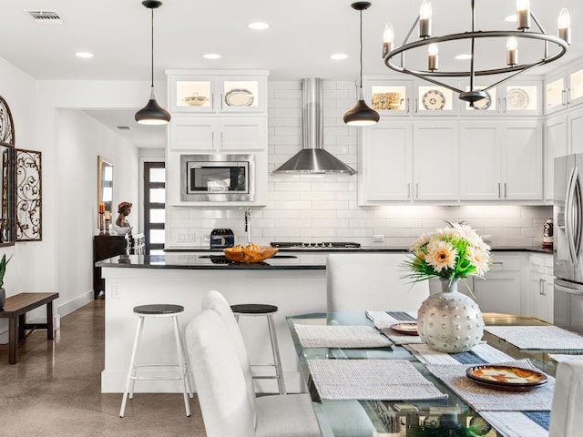 3711 Garden Villa Ln Unit A, Austin, TX 78704 - kitchen with wall chimney exhaust hood, appliances with stainless steel finishes, dark countertops, backsplash, and recessed lighting