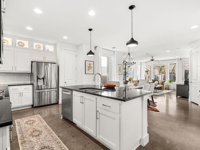 3711 Garden Villa Ln Unit A, Austin, TX 78704 - kitchen featuring stainless steel appliances, recessed lighting, white cabinets, tasteful backsplash, and an island with sink