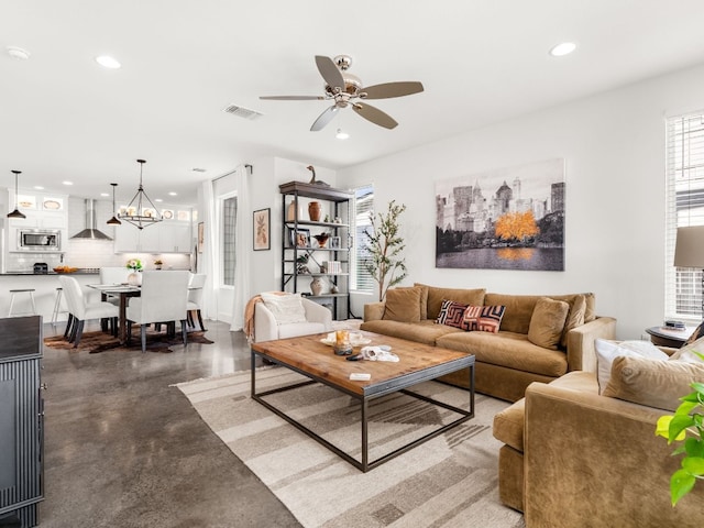 3711 Garden Villa Ln Unit A, Austin, TX 78704 - living area featuring concrete flooring, recessed lighting, a ceiling fan, and a chandelier
