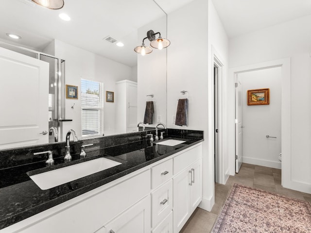 3711 Garden Villa Ln Unit A, Austin, TX 78704 - bathroom featuring double vanity, a stall shower, recessed lighting, and tile patterned floors