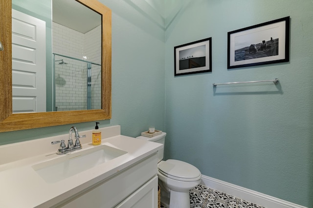 bathroom with vanity, tile patterned flooring, a shower with shower door, and toilet