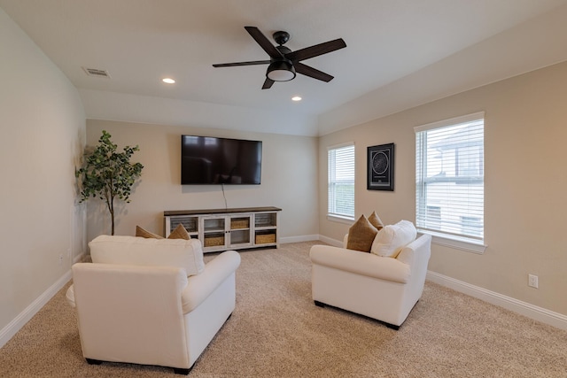 carpeted living room with ceiling fan