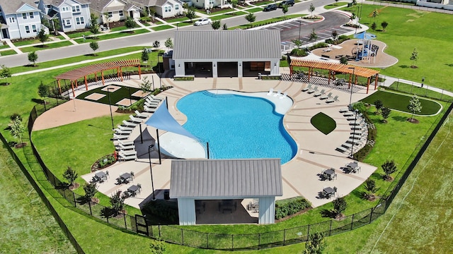 view of pool with a yard, a pergola, and a patio area