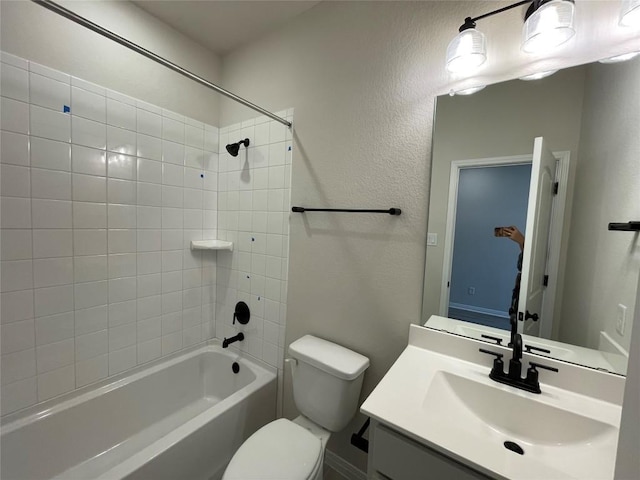 full bathroom featuring vanity, toilet, and tiled shower / bath