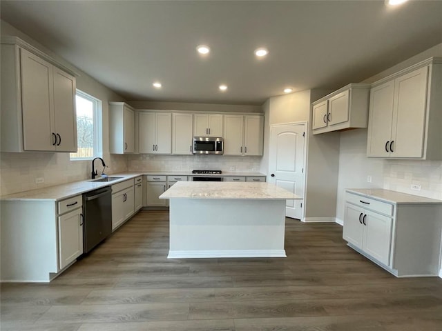 kitchen with appliances with stainless steel finishes, a kitchen island, and white cabinets