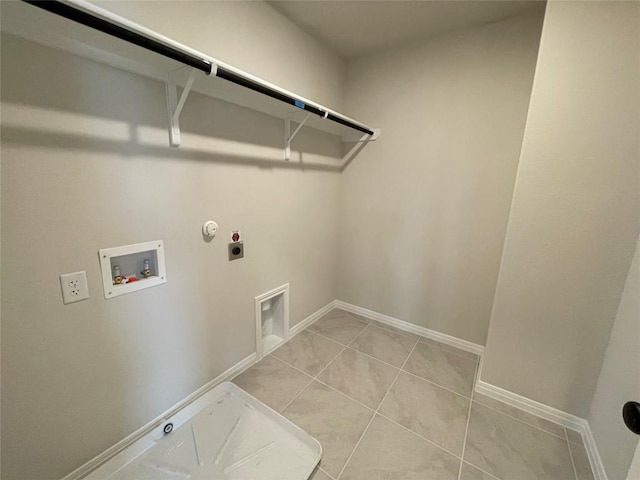 laundry area featuring gas dryer hookup, washer hookup, light tile patterned flooring, and electric dryer hookup