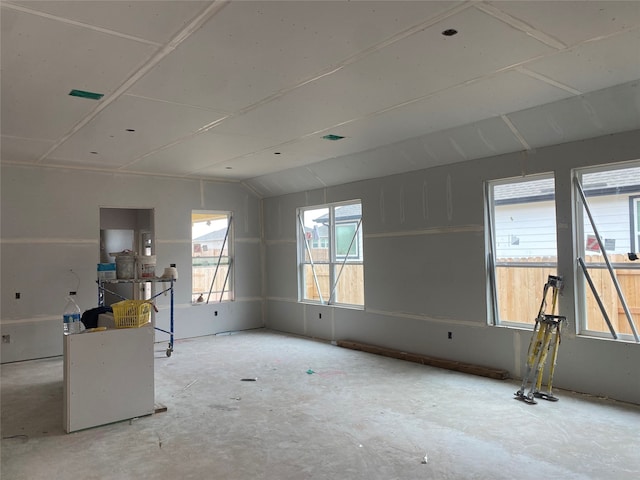 unfurnished living room featuring lofted ceiling