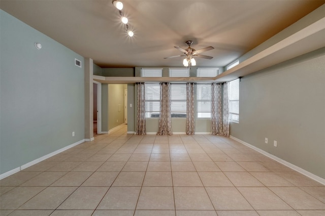 tiled spare room with ceiling fan