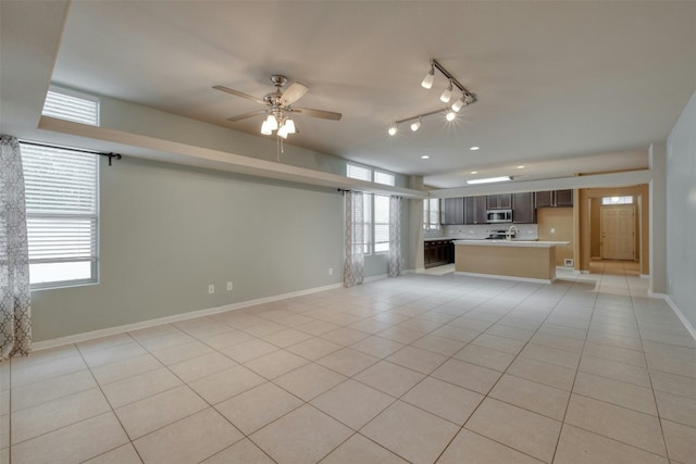 unfurnished living room with light tile patterned flooring and ceiling fan