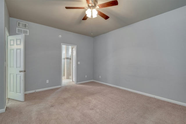 empty room featuring light colored carpet and ceiling fan