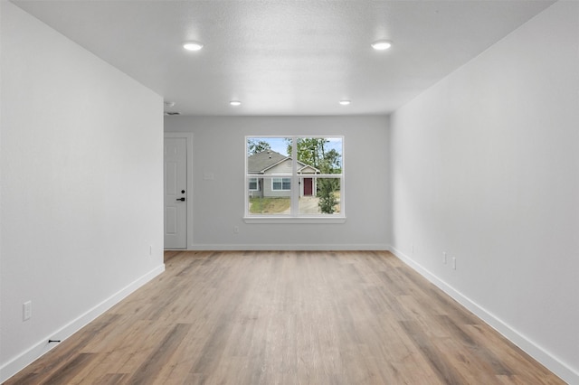 unfurnished room with light hardwood / wood-style floors