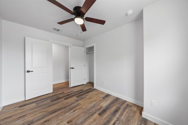 unfurnished bedroom with dark wood-type flooring and ceiling fan