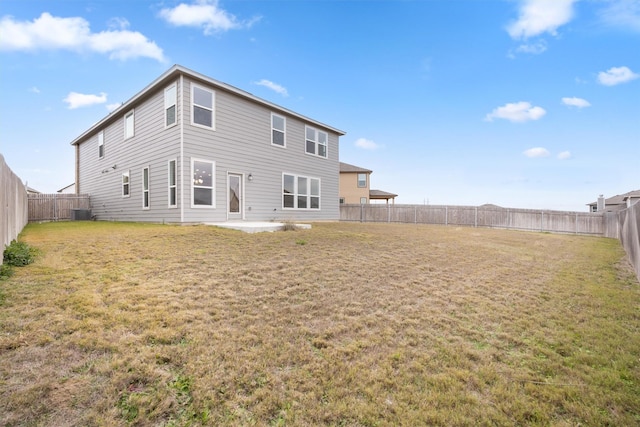 back of house featuring a patio and a lawn