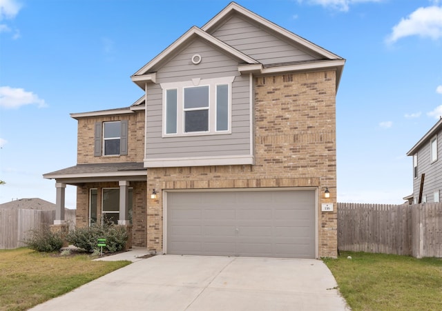 view of front of home featuring a garage and a front lawn