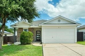 ranch-style house with a garage and a front lawn