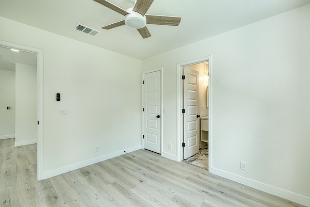 unfurnished bedroom featuring ceiling fan, light wood-type flooring, and ensuite bath