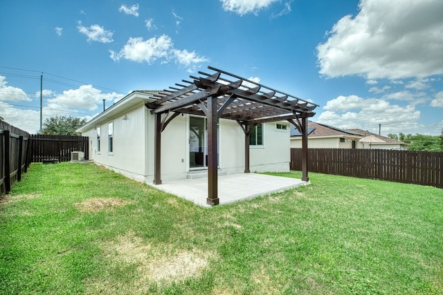 back of house featuring a lawn, a patio area, and a pergola