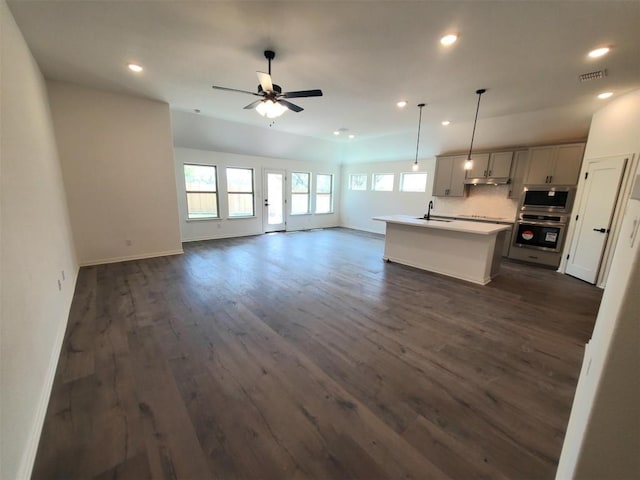 1501 Cole Estates Dr, Georgetown, TX 78628 - unfurnished living room with a sink, a ceiling fan, recessed lighting, dark wood-style floors, and baseboards