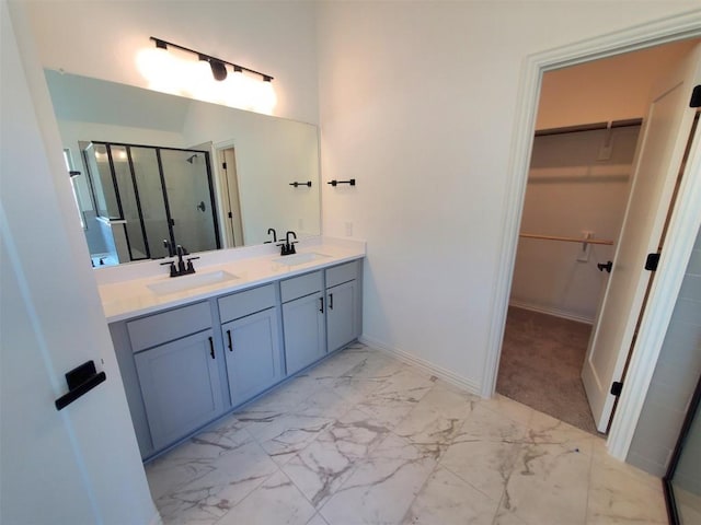 1501 Cole Estates Dr, Georgetown, TX 78628 - full bathroom featuring a stall shower, a walk in closet, marble finish floors, double vanity, and baseboards