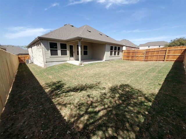 1501 Cole Estates Dr, Georgetown, TX 78628 - back of property featuring a patio area, a fenced backyard, and a shingled roof