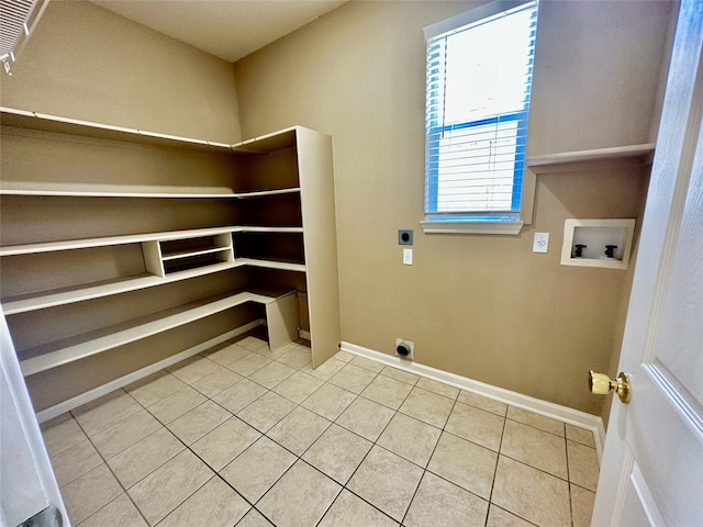 laundry room with hookup for a washing machine, electric dryer hookup, and tile patterned flooring