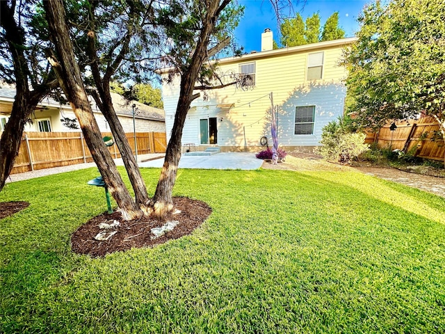 rear view of house with a patio and a yard