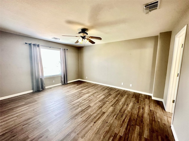 unfurnished room with dark wood-type flooring, a textured ceiling, and ceiling fan