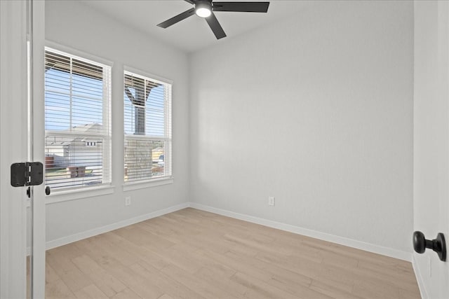 empty room featuring a healthy amount of sunlight, ceiling fan, and light hardwood / wood-style flooring