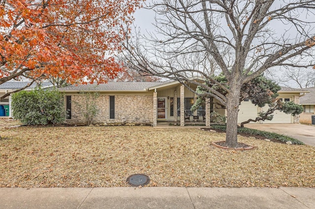 ranch-style home with a garage and a front yard