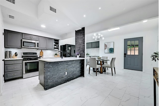 kitchen featuring marble finish floor, a center island with sink, open shelves, stainless steel appliances, and light countertops