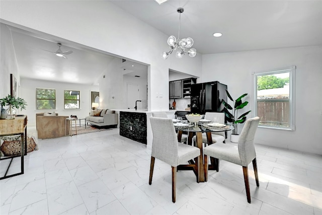 dining room with marble finish floor, plenty of natural light, and recessed lighting