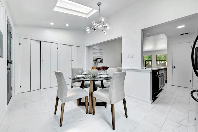 dining room featuring a skylight, marble finish floor, a notable chandelier, and recessed lighting