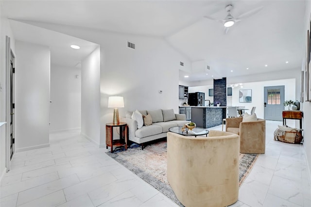 living room with baseboards, a ceiling fan, marble finish floor, vaulted ceiling, and recessed lighting