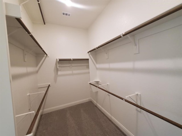 walk in closet featuring dark colored carpet and visible vents